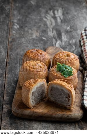 Mini  Melton Mowbray Pork Pies On Rustic Wooden Table