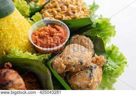 Nasi Tumpeng. Indonesian Cuisine Yellow Rice On Banana Leaf