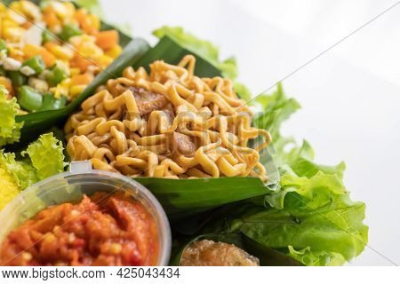 Nasi Tumpeng. Indonesian Cuisine Yellow Rice On Banana Leaf