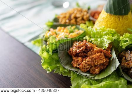 Nasi Tumpeng. Indonesian Cuisine Yellow Rice On Banana Leaf