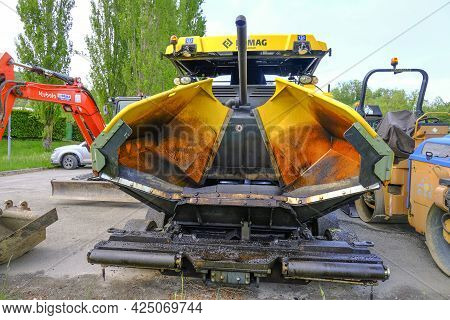 June 2021 Parma, Italy: Huge Yellow Heavy Road Machine Close-up Parked And Ready For Road Constructi
