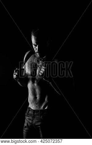 Man Silhouette Hold Leather Belt. Fashion Portrait Of Strong Guy In Dark. Desire And Seduction. Hand