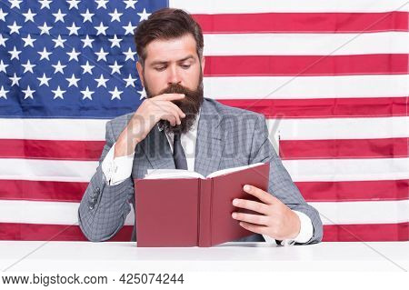 All Should Have Freedom To Pursue Education. Teacher Read Book On American Flag. Education In Usa. A