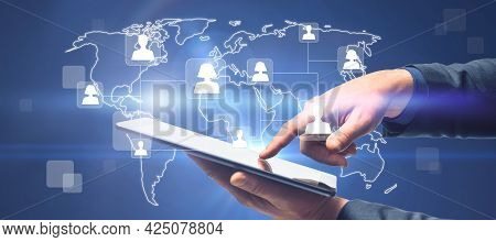 Close Up Of Hands Using Tablet With Glowing Map And People Icons. Social Media And Online Recruiting