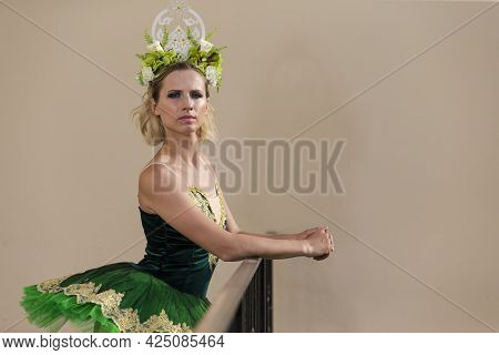 Dancing Concepts. Portrait Of Professional Caucasian Ballet Dancer In Green Tutu Dress Making Up Her