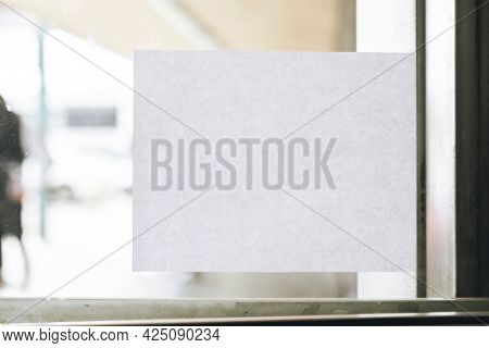 Rectangle paper sign on a glass door