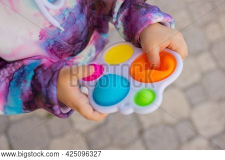Pop It Fidget Toy In Girl Hands. Colorful Antistress Kids Toy Fidget.
