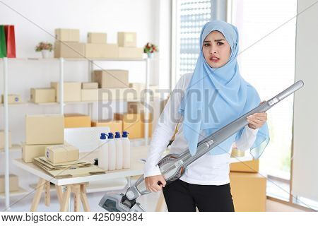 Happy Young Beautiful Asian Muslim Housewife Woman Cleaning And Playing Vacuum Cleaning Like Guitar 