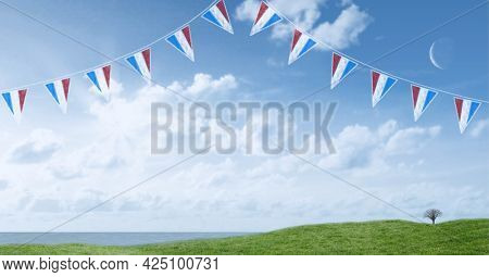 Composition of pennants with red, white and blue of american flag, over blue sky and green field. patriotism, independence and labor day celebration concept digitally generated image.