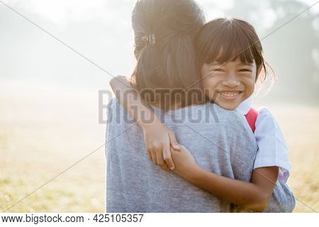 Asian Mother Embrace And Hug Her Daughter Going To School