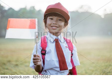 Indonesian School Student Holding Flag During Independence Day.