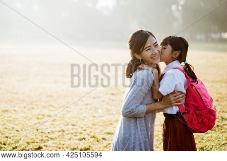 Mother Taking Her Daughter To School In The Morning
