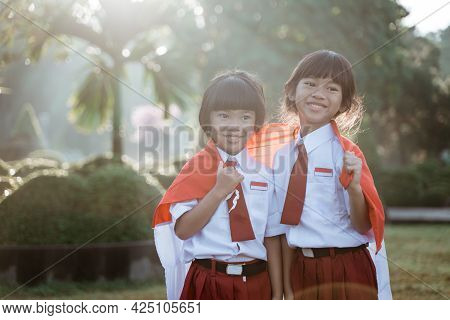 Indonesian School Student Holding Flag During Independence Day.