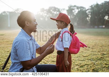 Father Taking Her Daughter To Primary School In The Morning