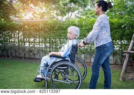 Doctor Help And Care Asian Senior Or Elderly Old Lady Woman Patient Sitting On Wheelchair At Park In