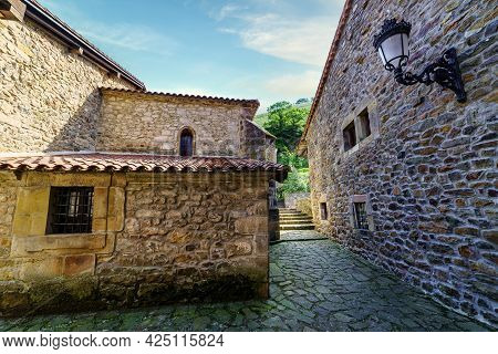 Old Stone Houses And Narrow Alley In Mountain Village. Barcena Mayor Santander.