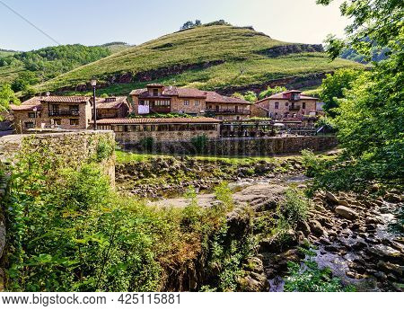 Stream Passing Next To An Old Mountain Town. Barcena Mayor Santander.