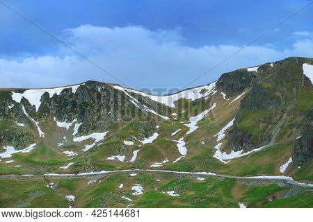 Beautiful scenic view in a rainy and cloudy day over the Transalpina road, the highest mountain road in the Carpathians located in the Parang mountains, Romania, Europe