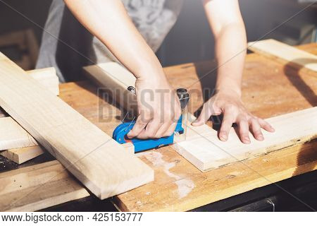 Entrepreneur Woodwork Holding A Tacker To Assemble The Wood Pieces As The Customer Ordered.