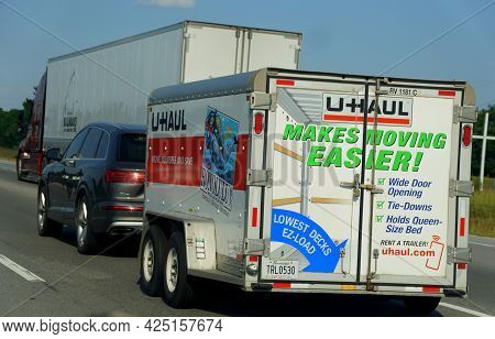 Bowling Green, Kentucky, U.s.a - June 16, 2021 - An Suv Towing A U-haul Small Trailer On The Highway