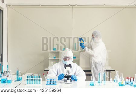 Two Asian Scientist Team Reserch Chemistry Science Tube Experiment Biotech Antibody Sample In Labora