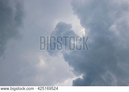 Sun Barely Breaks Through Cumulus Storm Clouds Before Rain, Disturbing Background