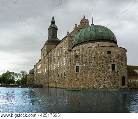 Vadstena, Sweden - May 23, 2021: A Part Of Castle In Medieval City Vadstena With Water Around The Ca