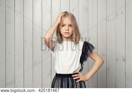 Oh, No. Photo Of Upset Blonde Teen Girl Made Big Mistake Feel Guilty. Studio Shot, Light Wooden Back