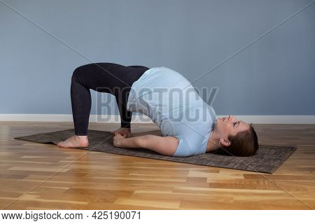 Pregnant Happy Fitness Person Enjoy Yoga Practice At Home.