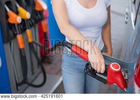 Caucasian Woman Refueling A Car At A Self-service Gas Station.