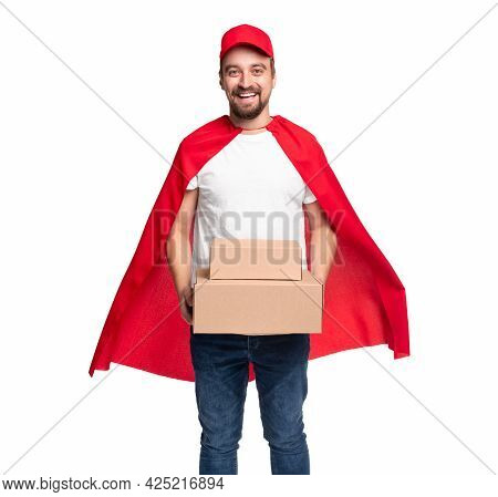 Happy Bearded Delivery Man In Red Superhero Cape And Cap Carrying Cardboard Boxes While Representing