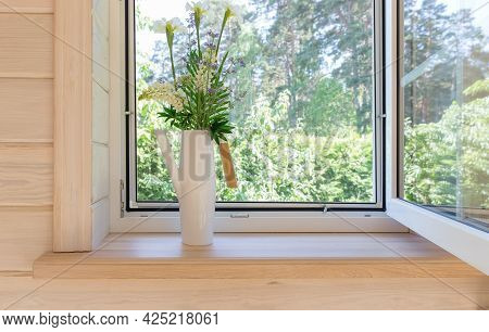 White Window With Mosquito Net In A Rustic Wooden House Overlooking The Garden. Bouquet Of White Iri