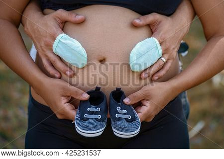 Photos Of A Pair Of Shoes And Stockings On A Pregnant Belly