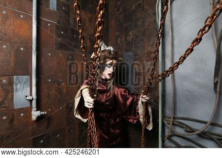 Aggressive stylish steampunk woman in a creative interior.