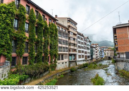 Beautiful Traditional Local Houses In The Town Of Azkoitia Next To The Urola River, Gipuzkoa. Basque