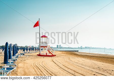 Beach At The Adriatic Sea Coastline In Italy, Europe During Summer. Traditional Hut For The Beach Li