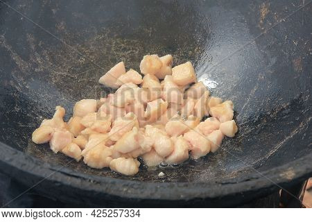 Pieces Of Raw Lamb Fat Dumba Are Fried In A Black Cauldron, Cooking Food