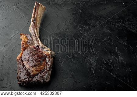 Steak On The Bone. Tomahawk Steak Freshly Grilled Dry Aged Bbq Food Set, On Black Stone Background, 