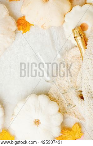 Cozy Still Life For Winter And Autumn Holiday With Wine Glasses Bottle, White Squash Pumpkin, Wollen