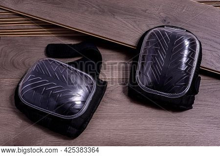 A Pair Of Knee Protectors Or Knee Pads For Work On Planks Of Laminate Floor. Selective Focus.