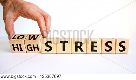 Low Or High Stress Level Symbol. Businessman Turns Wooden Cubes And Changes Words High Stress To Low