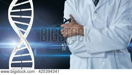 Mid section of male doctor holding a stethoscope against dna structure on blue background. medical research and science technology concept