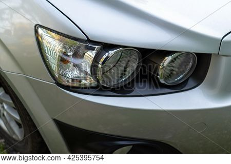 Car Headlight On A Gray Car Close-up