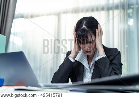 Exhausted Attractive Asian Business Woman Worker Look To Many Paper Work On Table At Workplace. Busy