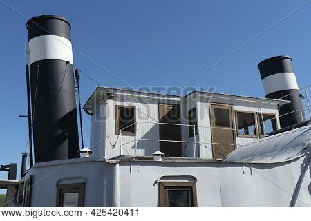 The Upper Deckhouse Of An Old Ship With Two Exhaust Pipes.