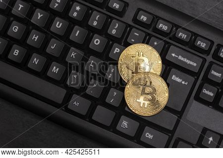 Two Gold Bitcoins On Computer Keyboard Close Up. Electronic Virtual Money. Mining Cryptocurrency Con