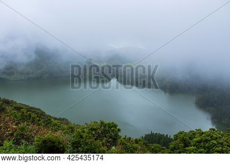 Deep lake in Flores Island, Azores Archipelago, Portugal. Green lagoon with green vegetation