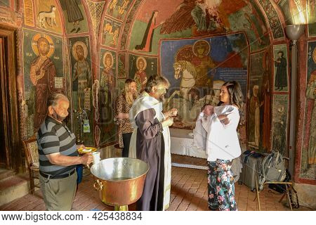 People During A Baptism On The Church Of Panagia Phorviotissa At Nikitari On Cyprus Island