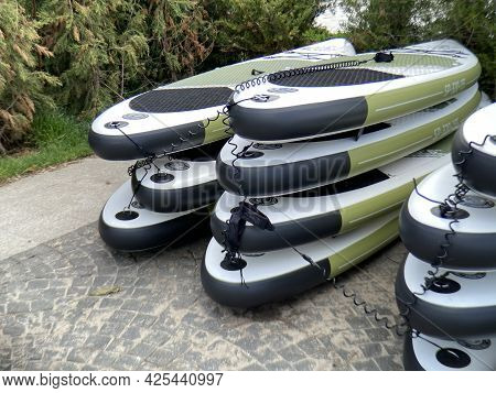 Many Paddle Boards On The Lake Shore. Supboard Water Tourism And Active Sports, Closeup