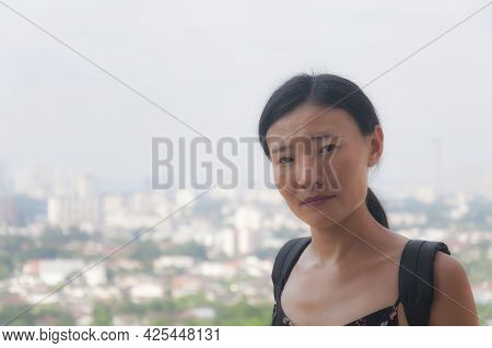 A Chinese Woman Standing Near A Window Within The Pagoda Of A Thousand Buddhas Atop Penang Hill At T